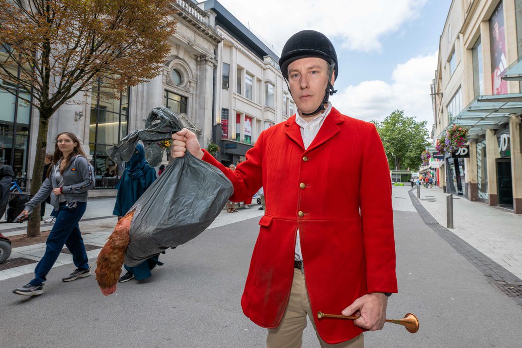 A campaigner in a hunting outfit protesting about fox hunting