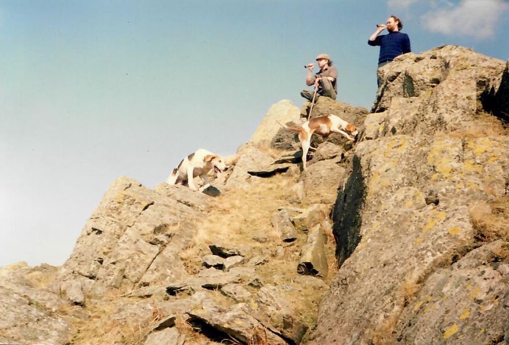 Two men on a rocky mountainside with hunting horns