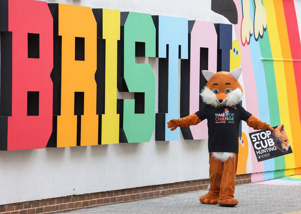 The League fox in front of a Bristol mural